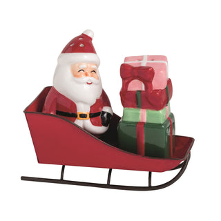 Decorative figure of Santa Claus in a sleigh with presents on a white background