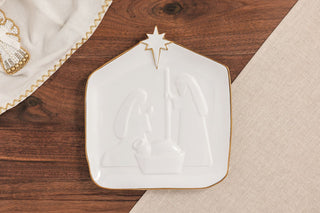 Decorative white plate with gold rim on a wooden surface