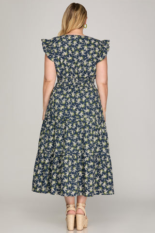Woman wearing a floral dress with a plain background