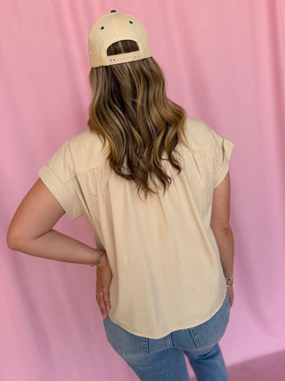 girl wearing a beige top