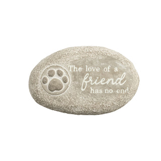 Decorative stone with paw print and text 'The love of a friend has no end' on a white background
