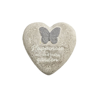 Heart-shaped stone with butterfly and text 'Happiness is found in the garden' on a white background