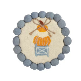 Decorative item with a character in an orange sweater and blue box, surrounded by gray beads on a white background.
