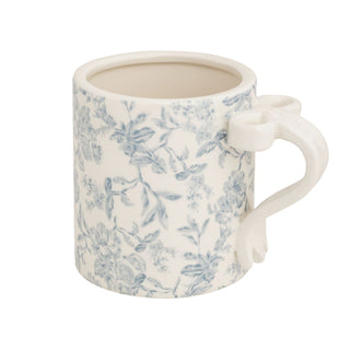 Ceramic mug with blue floral pattern on a white background