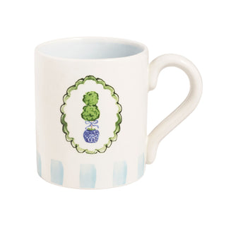 White mug with decorative green and blue design on a white background