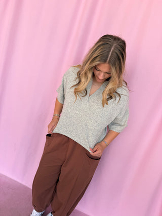  girl wearing a grey top 