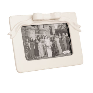 White photo frame with a bow on a white background