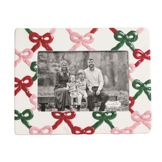 Decorative picture frame with colorful bows and a family photo inside