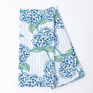 Floral-patterned fabric with blue and green flowers on a white background