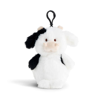 Small plush cow toy with a black clip on a white background
