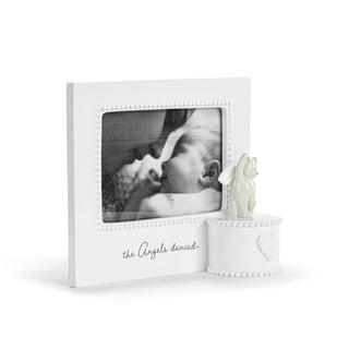 White photo frame with a baby picture and decorative item on a white background