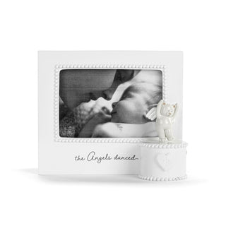 White photo frame with a small angel figurine on a white background