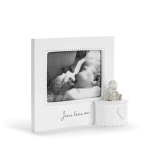 White photo frame with a baby picture and decorative item on a white background