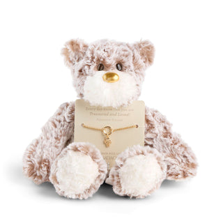 Plush teddy bear with a gold necklace on a white background