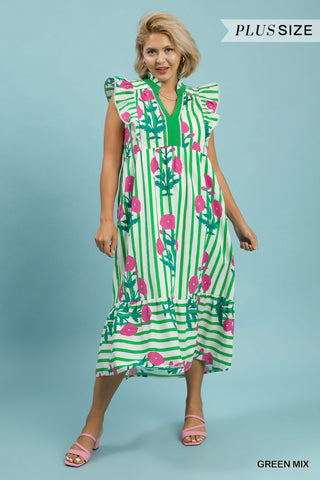 Woman wearing a green and pink striped dress with floral patterns on a blue background