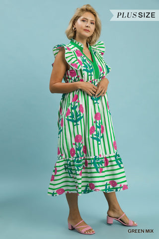Woman wearing a green and pink floral dress on a light blue background