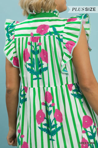 Green and white striped dress with pink floral patterns on a person against a light blue background.