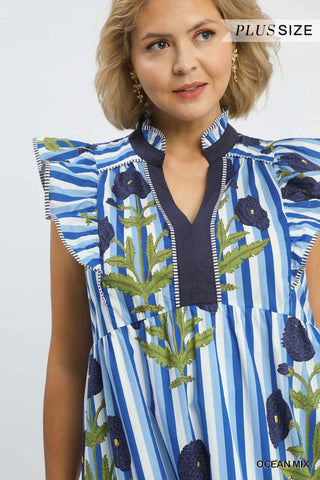 Woman wearing a blue and green patterned dress with 'Plus Size' text above.