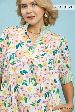Woman wearing a plus-size floral dress with a blue background
