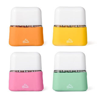 Four colorful containers with white lids on a white background