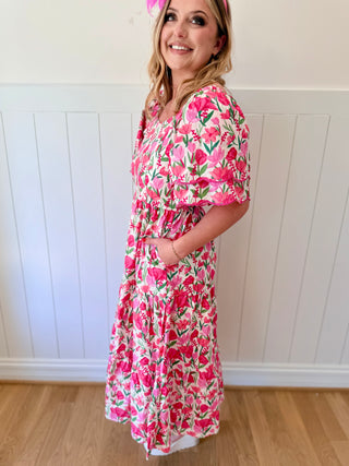 Woman wearing a floral dress with a white background