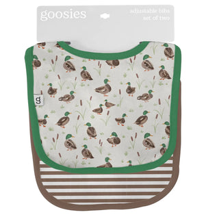Baby bib with duck pattern and green trim, branded 'goosies'.
