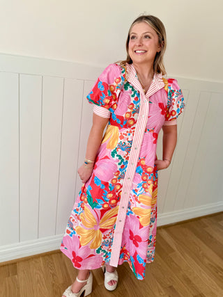 Woman wearing a colorful floral dress with a white background