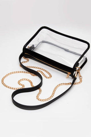 Black clear pouch with gold chain strap on a white background