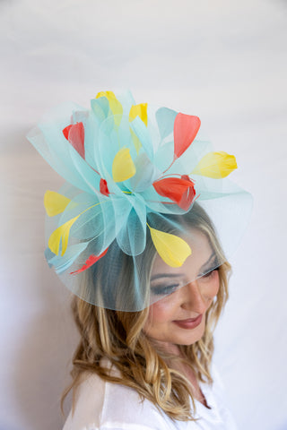 Woman wearing a colorful headpiece with a white background