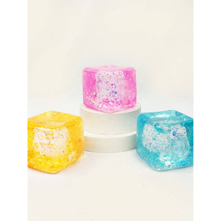 Three colorful soap bars in cube shape on a white background