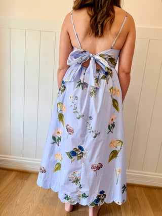 Woman wearing a floral dress with a white background