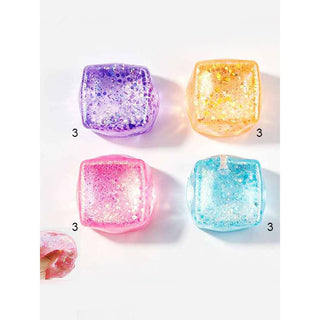 Four colorful glittery cubes on a white background