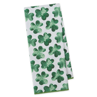 White towel with green shamrock pattern on a white background