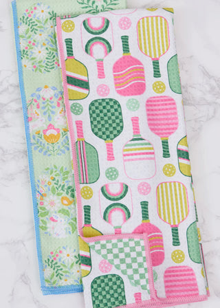 Two colorful patterned cloths on a marble surface