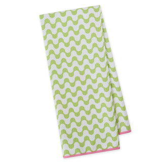 Green and white wavy patterned towel on a white background