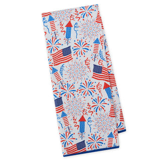 Folded towel with patriotic design featuring American flags and fireworks on a white background