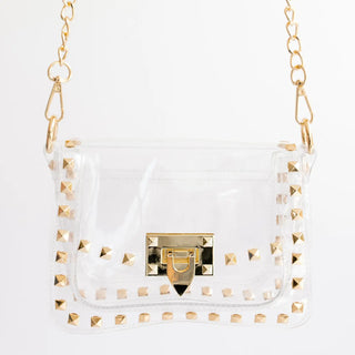 Clear handbag with gold studs and chain strap on a white background