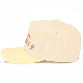 Beige cap with colorful text on a white background