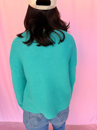 woman wearing a blue sweater 