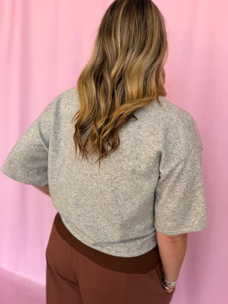 girl wearing a grey top 
