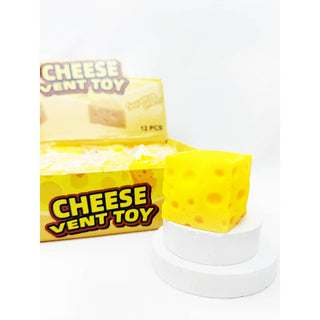 Yellow cheese-shaped vent toy with packaging on a white background