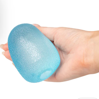 Hand holding a blue egg-shaped object against a white background