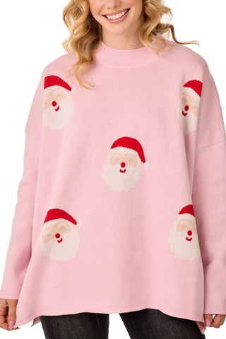 Person wearing a pink sweater with Santa face patterns on a white background