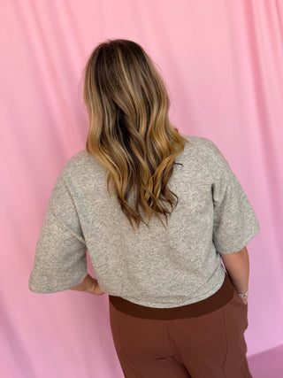 girl wearing a grey top 