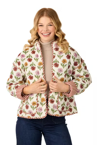 Woman wearing a floral patterned jacket on a white background