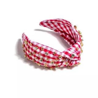 Red and white checkered headband with gold embellishments on a white background