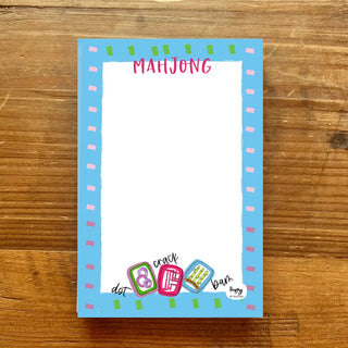Mahjong-themed notepad with colorful border on a wooden surface