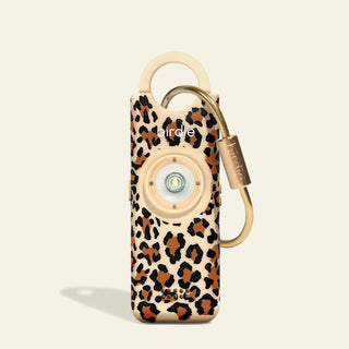 Leopard print device with a gold carabiner on a beige background