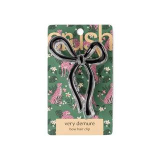 Bow hair clip on a floral patterned card with 'very demure' text