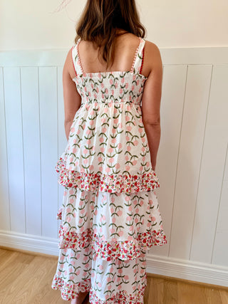 Person wearing a floral dress with a white paneled wall background